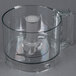 A clear Robot Coupe cutter bowl with a white blade inside.