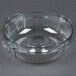 A clear plastic bowl with handles and a lid.