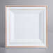 A white square plate with rose gold bands on the edges.