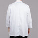 The back of a person wearing a white Chef Revival chef coat.