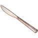 A Visions rose gold plastic knife with a textured handle.