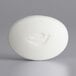A white oval Dove beauty bar soap with the word "Dove" carved on it.