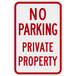 A white rectangular aluminum sign with red text reading "No Parking / Private Property" and a red border.