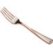 A close-up of a Visions rose gold plastic fork.