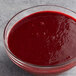 A bowl of Les Vergers Boiron Morello cherry fruit puree on a table.