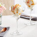 A pair of Acopa Covella margarita glasses with ice cream and caramel sauce.