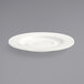 A white Front of the House porcelain saucer with a small rim on a gray surface.