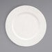 A white Front of the House Catalyst Facet porcelain plate with a pattern on the rim.