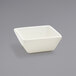 A Front of the House Catalyst Kyoto European White Tall Square Porcelain Sauce Dish on a gray background.