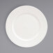 A Front of the House Catalyst European white porcelain plate with an embossed pattern.