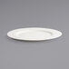 A Front of the House Catalyst Classic European White porcelain plate with a wide rim on a gray surface.
