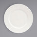 A white plate with an embossed spiral design.