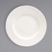 A white Front of the House Catalyst porcelain plate with a wavy pattern.