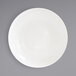 A white porcelain bowl with a white rim on a white surface.