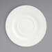 A white porcelain saucer with a small rim.