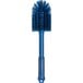 A blue brush with a long handle and bristles.