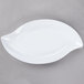 A white oval melamine platter with a leaf design.