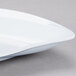 A GET San Michele white platter with a curved edge.