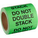 A roll of green Lavex Do Not Double Stack labels with black text.