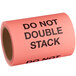 A roll of red paper labels that reads "Do Not Double Stack" in black text.
