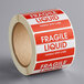 A roll of Lavex fragile liquid labels with a white background.