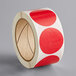 A roll of red and white round Lavex stickers with a white background.