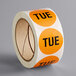 A roll of orange Lavex Tuesday inventory labels.