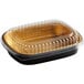 A Choice black and gold aluminum foil entree pan with a clear plastic lid.