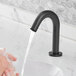A person washing their hands with a black Waterloo hands-free faucet.