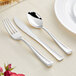 A Visions Classic silver plastic cutlery set with a spoon and knife on a table.