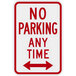 A white sign with red text that says "No Parking Any Time" and two red arrows pointing in opposite directions.