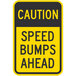A yellow and black rectangular aluminum sign that says "Caution Speed Bumps Ahead" with black letters and a yellow background.