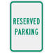 A white and green sign that says "Reserved Parking" in green text.