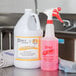 A white 32 oz. labeled bottle of Noble Chemical All Purpose Cleaner on a counter.