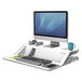 A white Fellowes Lotus sit/stand workstation with a keyboard and computer monitor.