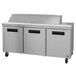 A stainless steel refrigerated sandwich prep table with three doors.