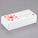 A white 1 lb. Valentine's Day candy box with red hearts.
