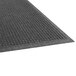 A close-up of a charcoal Guardian EcoGuard wiper mat with a grey pattern.