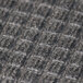 A close up of the gray and black fabric of a Guardian EcoGuard Wiper Mat.