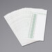 A stack of white Acroprint weekly time cards with green text.