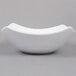 A white American Metalcraft square stoneware bowl with a curved edge on a gray background.