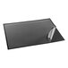 A black rectangular desktop organizer with a clear corner over a black and white drawing pad.