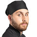 A man with a beard wearing a black Uncommon Chef skull cap.
