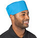A man wearing a blue Uncommon Chef skull cap with a smile.
