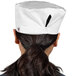 A woman wearing a white Uncommon Chef mesh top chef hat.
