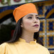 A woman wearing an Uncommon Chef yellow chef skull cap.