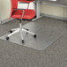 A red office chair on a rectangular clear studded mat.
