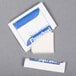A white Royal Paper wet nap packet with blue and white text.