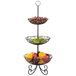 A Tablecraft three tiered black display basket with fruit on it.