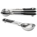 Two OXO stainless steel measuring spoons with black and silver handles.